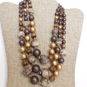 Vintage 3 strand bead necklace.  Shades of brown and gold.  Has moon glow beads